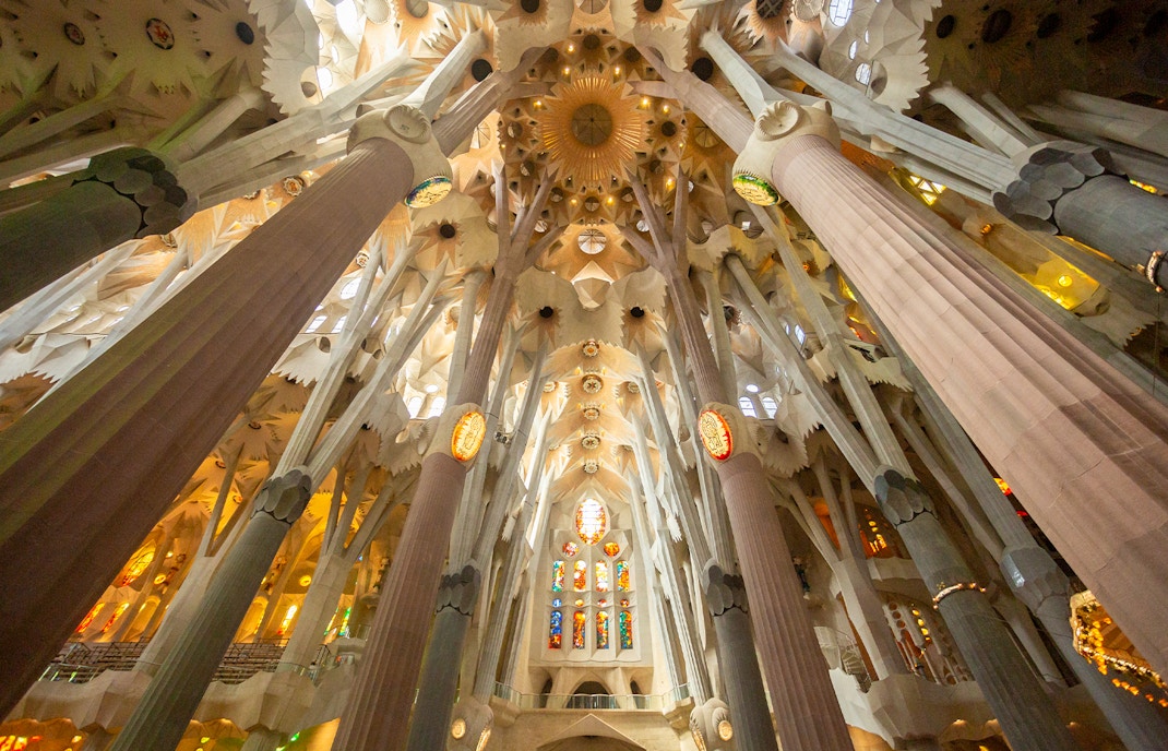 Sagrada Familia interior with stained glass windows and intricate architectural details, Barcelona.