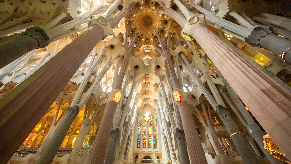 Sagrada Familia interior with stained glass windows and intricate architectural details, Barcelona.