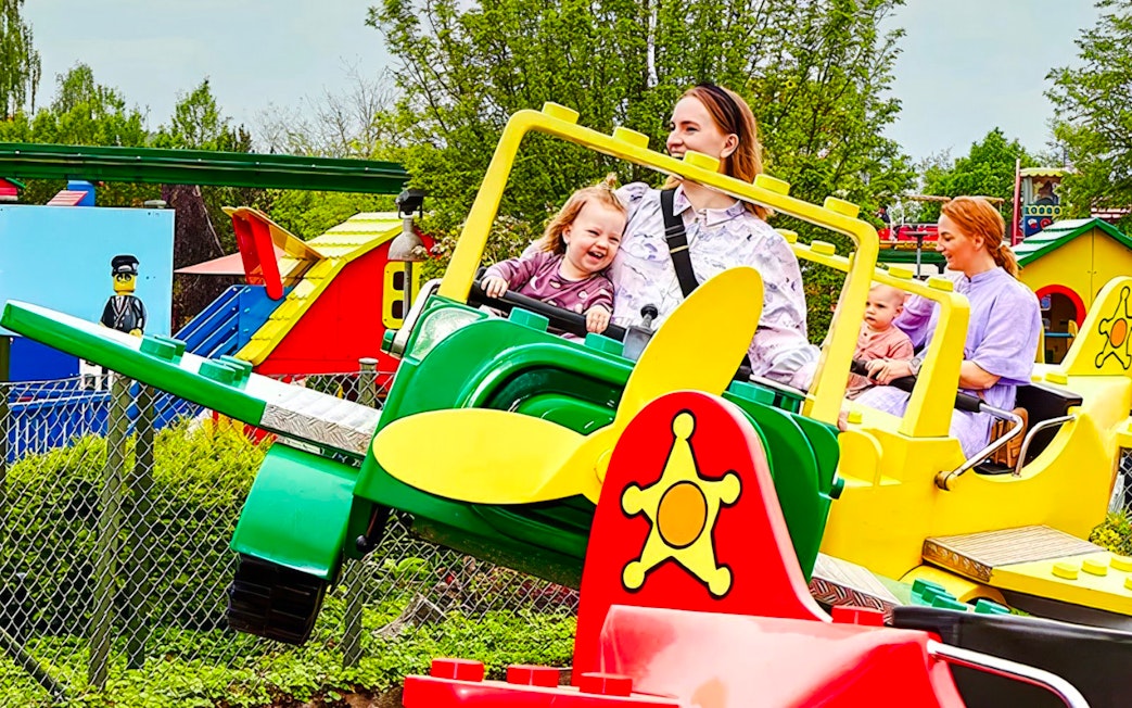 Guests enjoying a colorful airplane ride at LEGOLAND Billund.