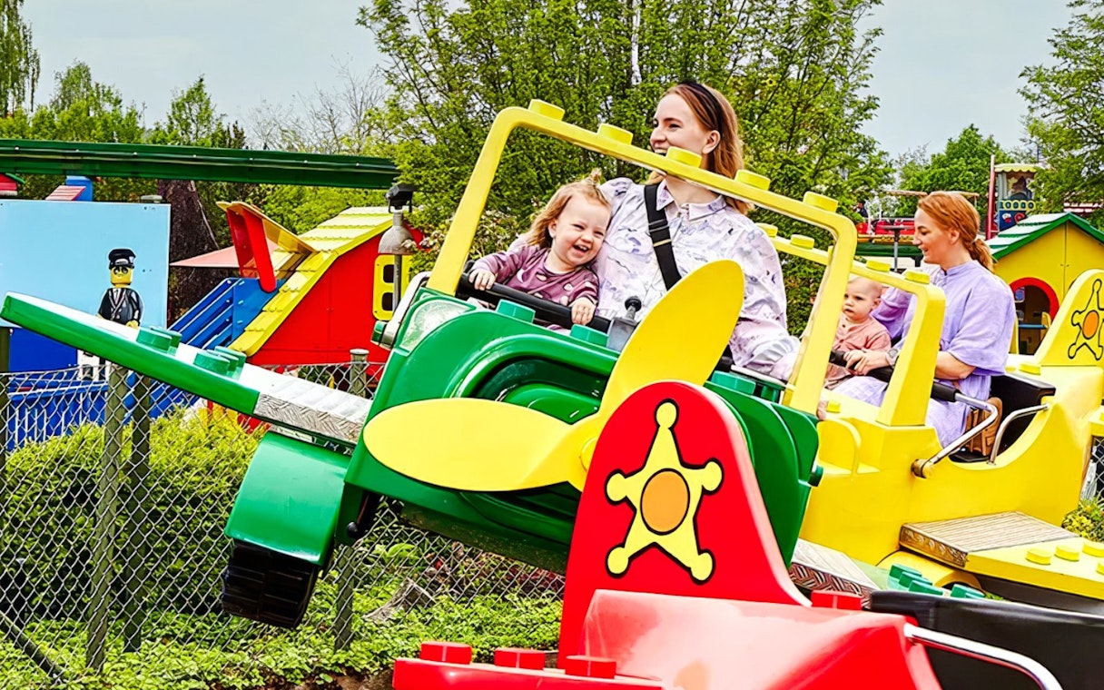 Guests enjoying a colorful airplane ride at LEGOLAND Billund.