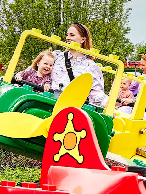 Guests enjoying a colorful airplane ride at LEGOLAND Billund.