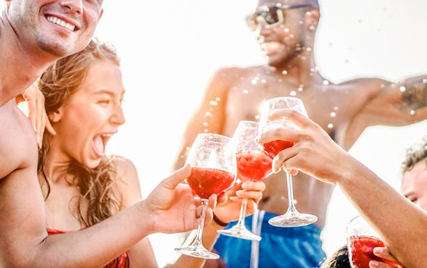 People enjoying drinks on a boat during Sail Amsterdam event.