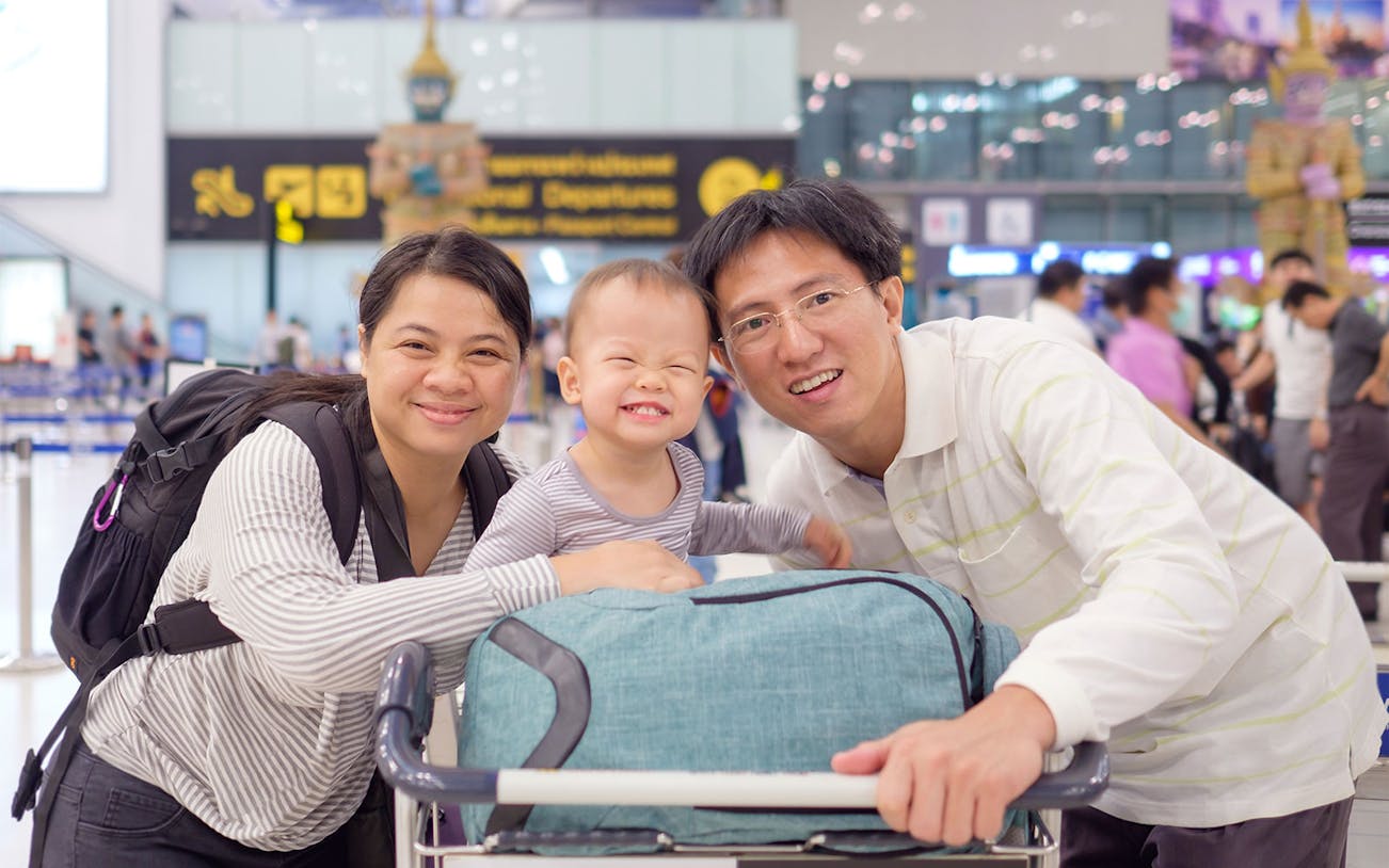 Family with luggage at Suvarnabhumi Airport, Bangkok, using VIP Fast-Track Service.
