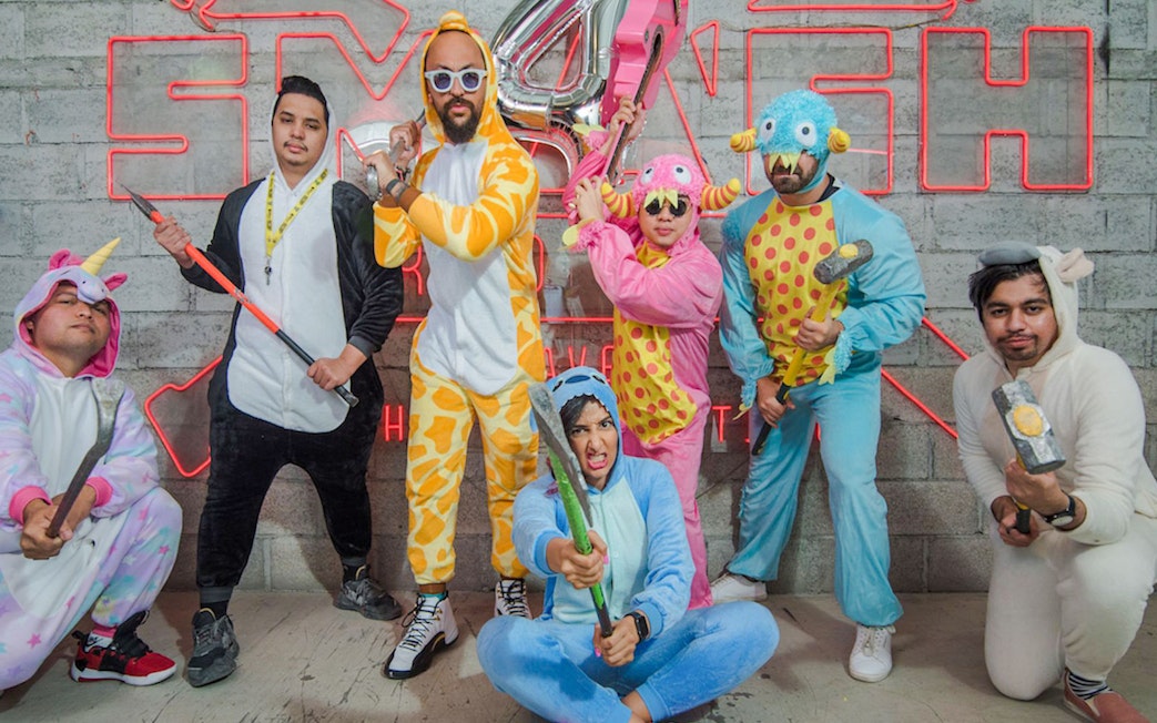 Visitors in costumes holding tools at Smash Room entrance.