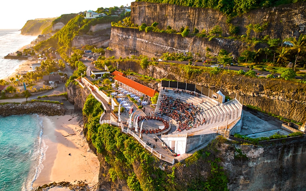Kecak and Fire Dance Show amphitheater at Melasti Beach, Bali, with ocean view.