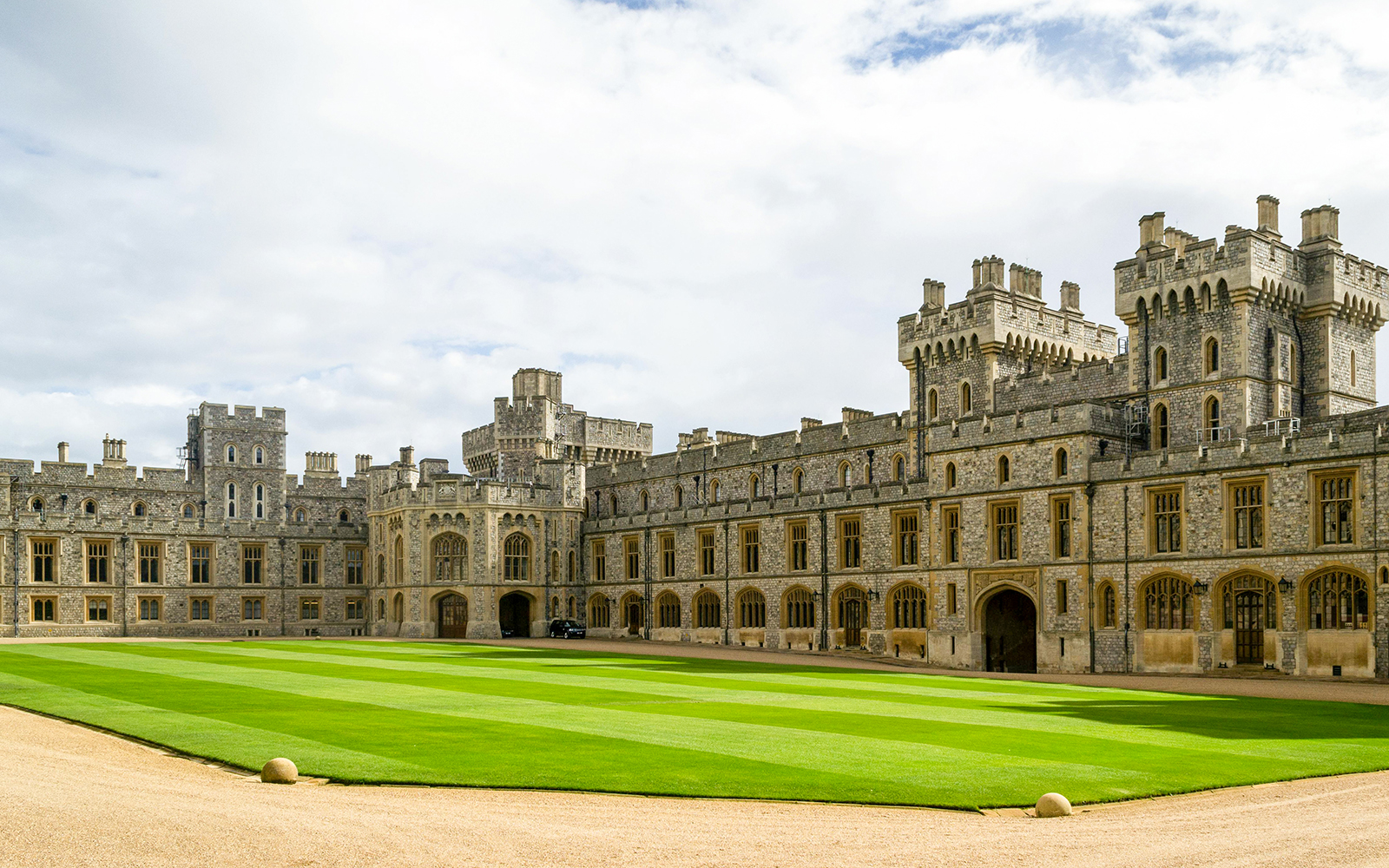 Windsor Castle courtyard with historic stone buildings and manicured lawn.