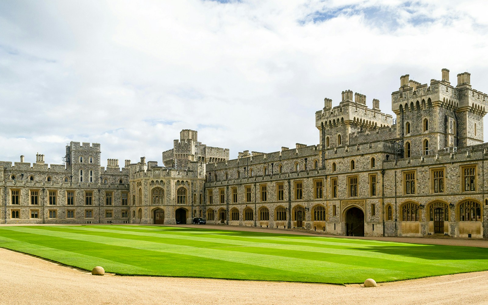 Windsor Castle courtyard with historic stone buildings and manicured lawn.