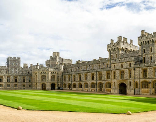 Windsor Castle courtyard with historic stone buildings and manicured lawn.