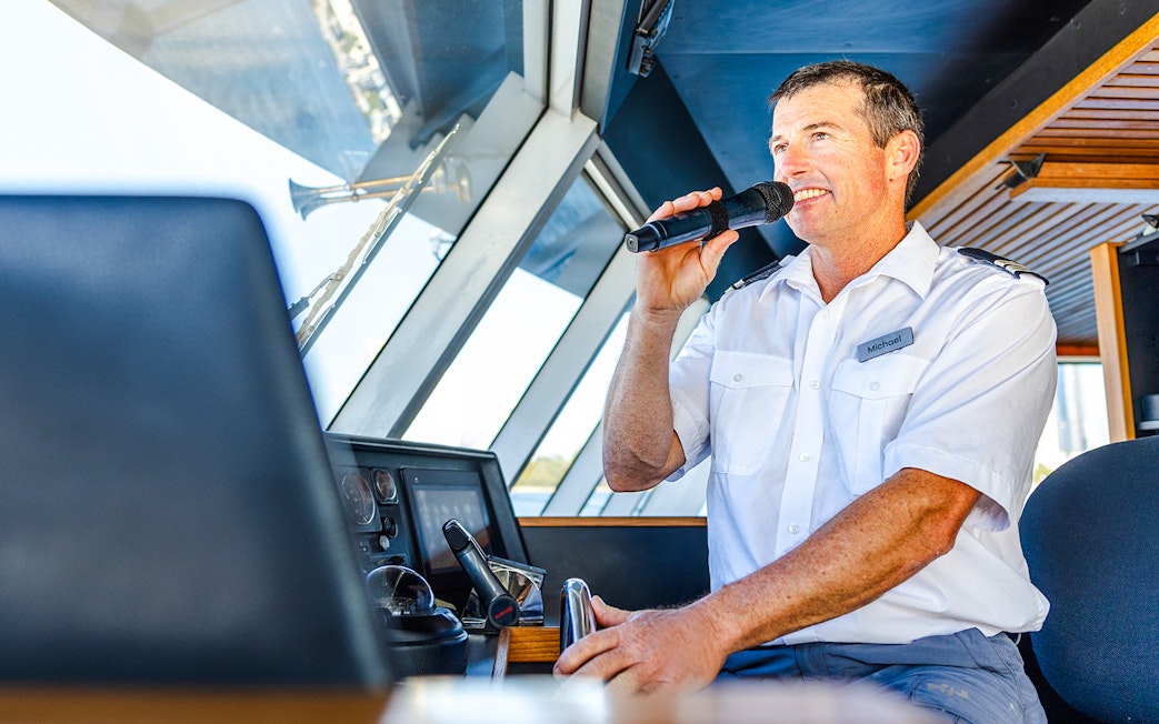 Skipper giving commentary during Gold Coast buffet lunch cruise.
