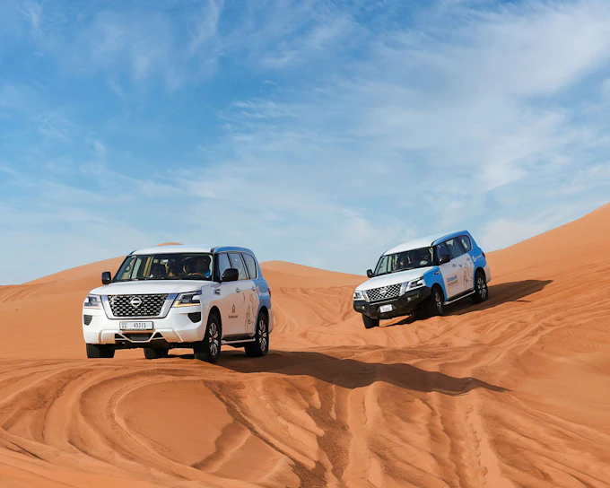 Abu Dhabi Premium Desert Safari with BBQ Dinner, Camel Ride and Sandboarding