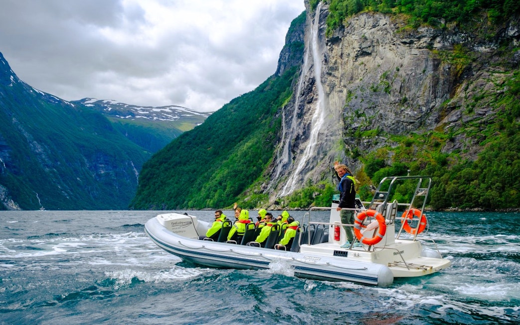 RIB boat on Geiranger Fjord near Hellesylt waterfall, Norway.