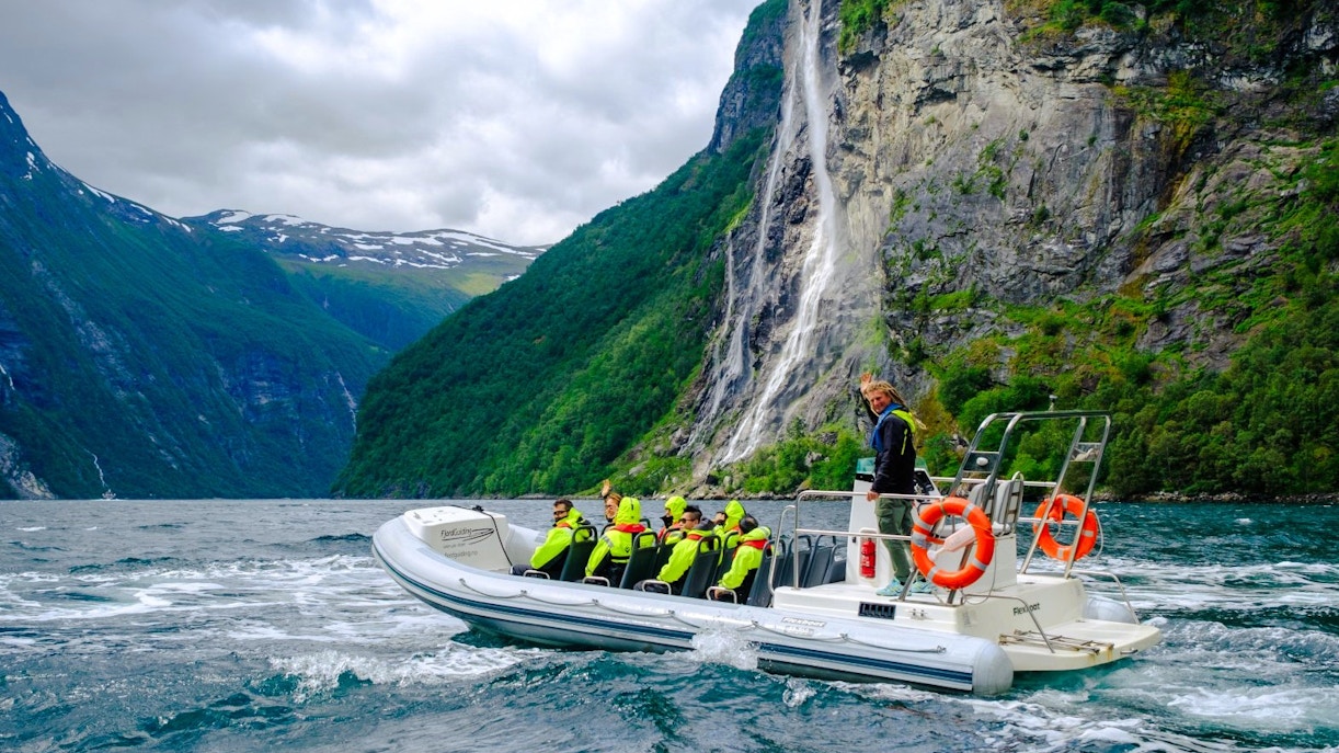 RIB boat on Geiranger Fjord near Hellesylt waterfall, Norway.