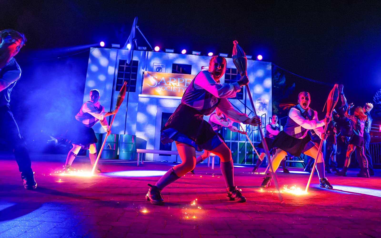 Performers with brooms in a Halloween show at Thorpe Park.