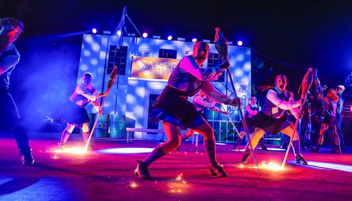 Performers with brooms in a Halloween show at Thorpe Park.