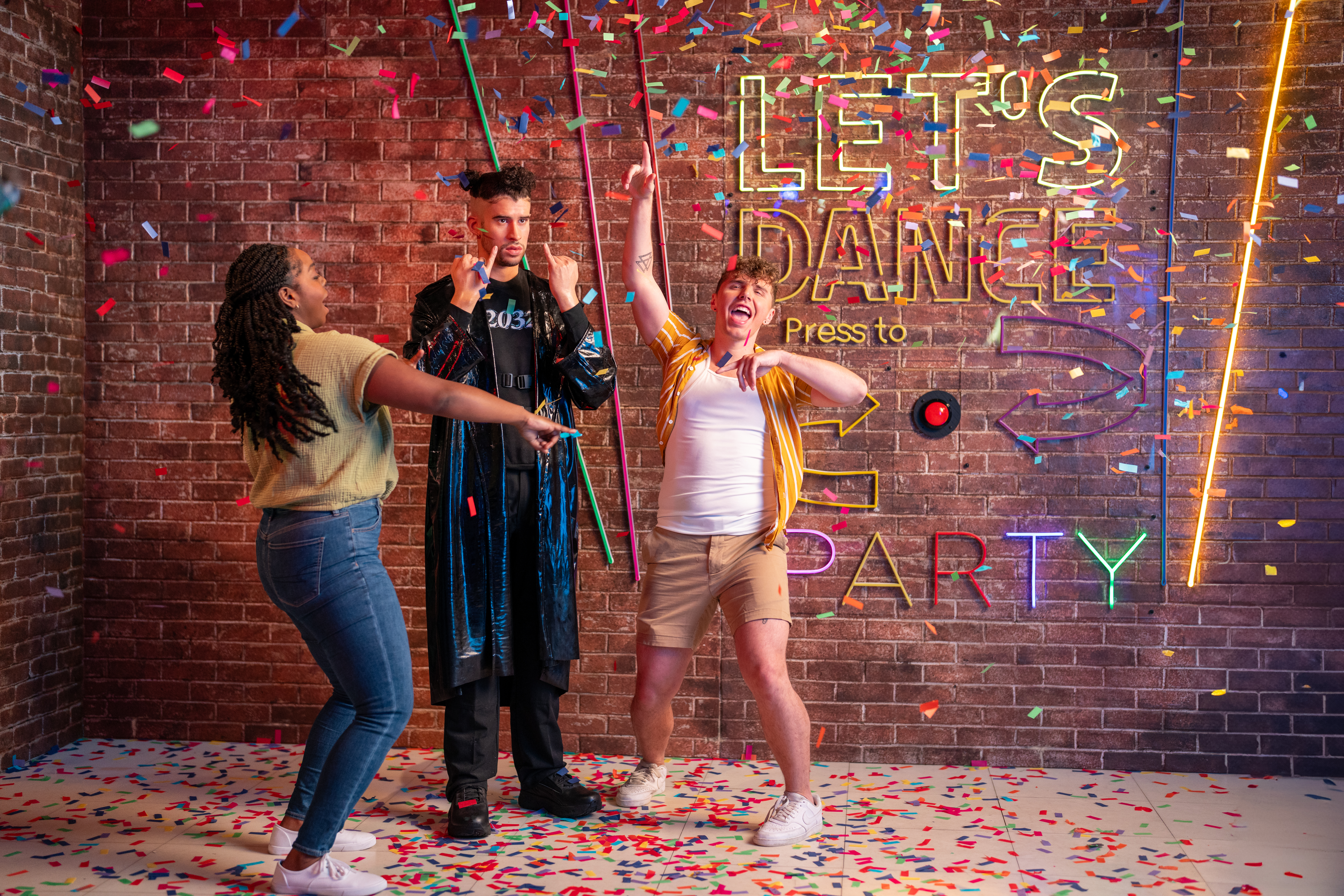 Visitors celebrating with confetti at Madame Tussauds Orlando dance party exhibit.