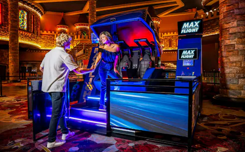 Max Flight Simulator experience in Las Vegas with two people preparing for a ride.