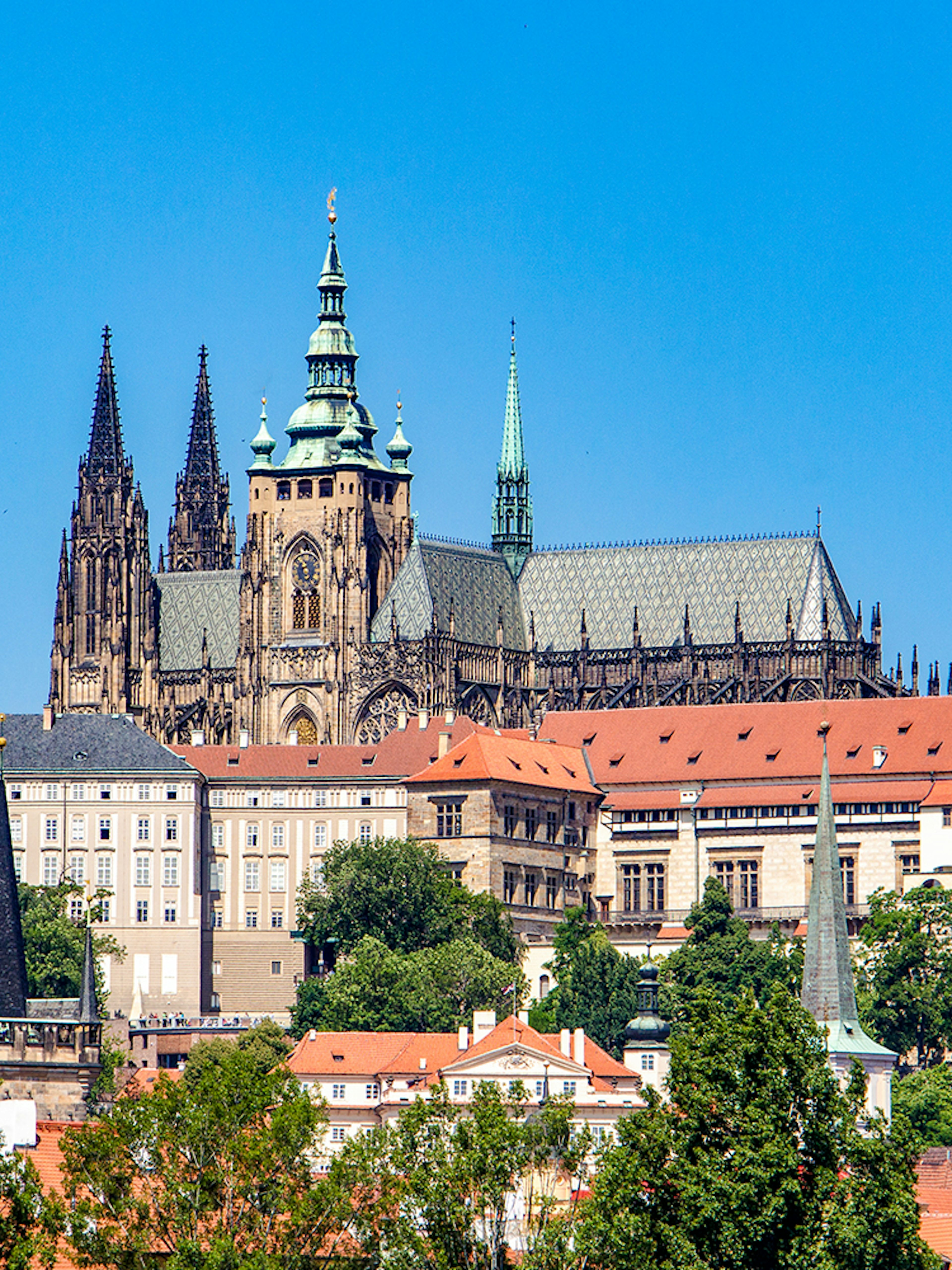 Prague Castle exterior with Gothic spires and red rooftops.