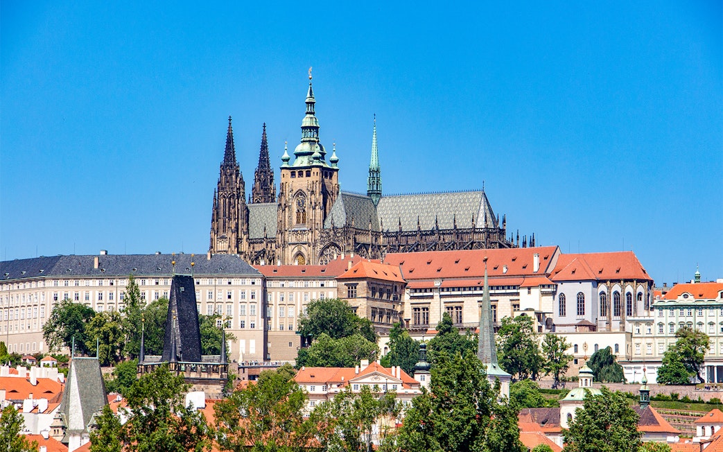 Prague Castle exterior with Gothic spires and red rooftops.