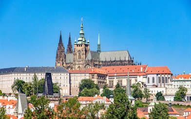 Prague Castle exterior with Gothic spires and red rooftops.