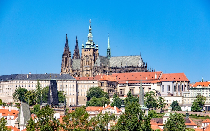 Prague Castle exterior with Gothic spires and red rooftops.