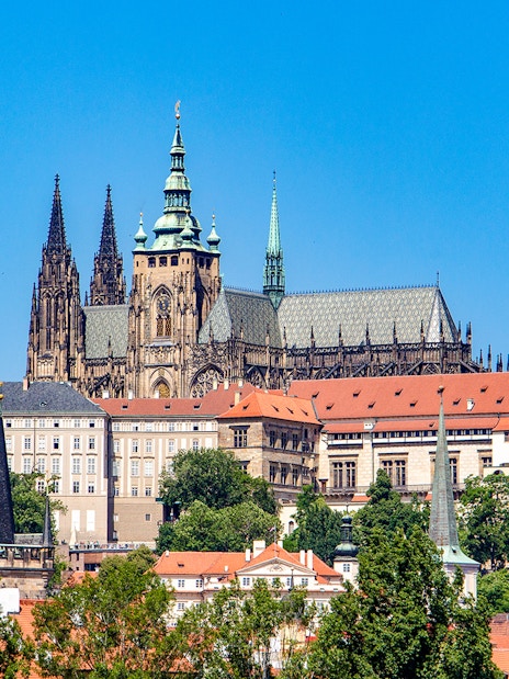 Prague Castle exterior with Gothic spires and red rooftops.