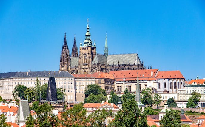 Prague Castle exterior with Gothic spires and red rooftops.