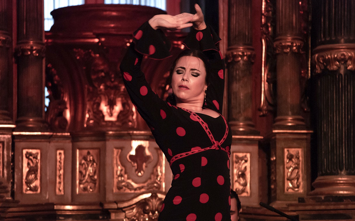 Flamenco dancer performing at Tablao El Arenal in Seville, Spain.