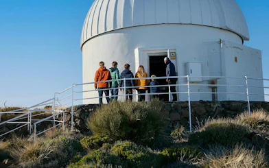 Visitors entering Teide Observatory dome during daytime tour.