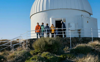 Visitors entering Teide Observatory dome during daytime tour.