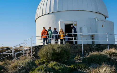 Visitors entering Teide Observatory dome during daytime tour.