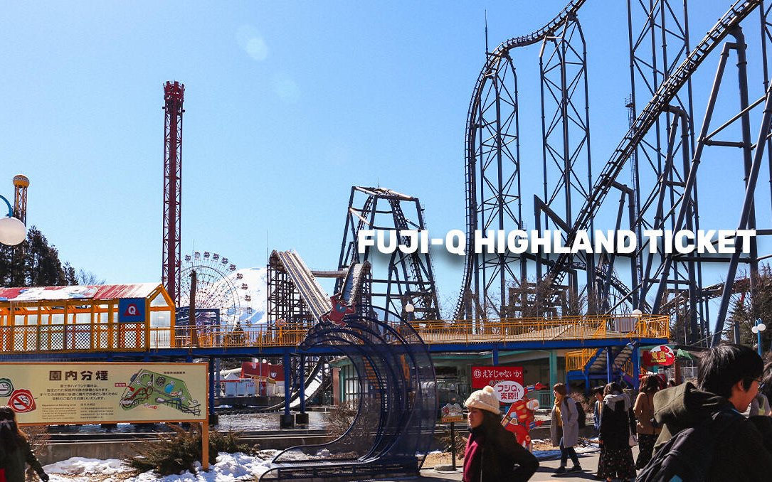 Fuji-Q Highland roller coasters and Ferris wheel under clear sky in Tokyo.