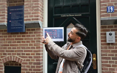 Tour guide explaining Corrie ten Boom House map in Haarlem during WWII walking tour.
