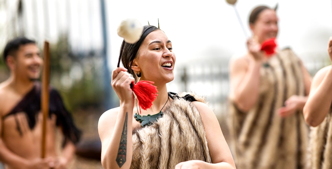 Maori performers in traditional attire performing a Haka in New Zealand.