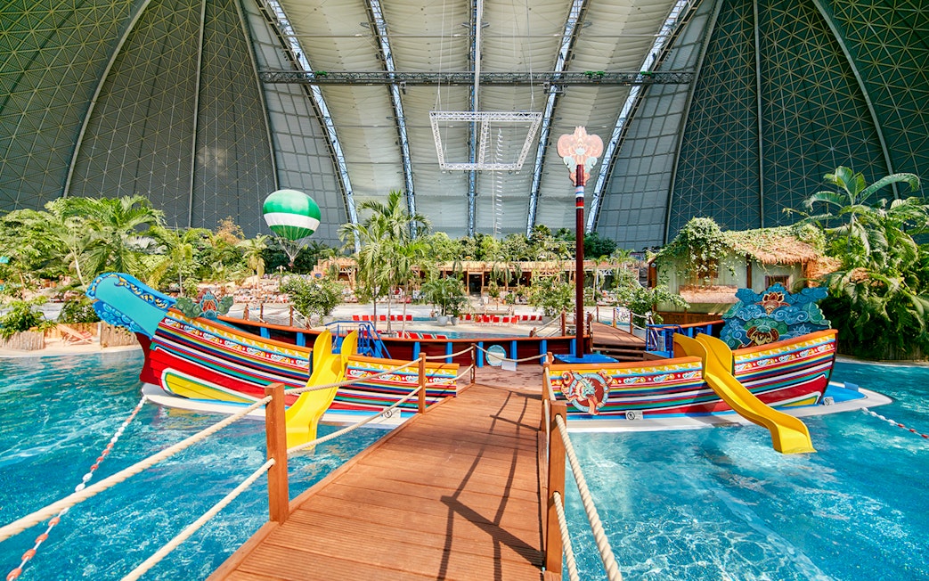 Colorful boat with slides in Tropical Islands Resort indoor water park.