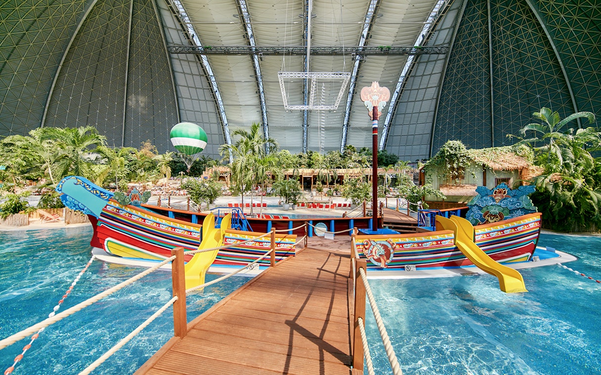 Colorful boat with slides in Tropical Islands Resort indoor water park.