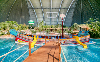 Colorful boat with slides in Tropical Islands Resort indoor water park.