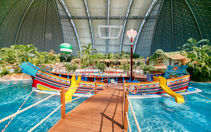 Colorful boat with slides in Tropical Islands Resort indoor water park.