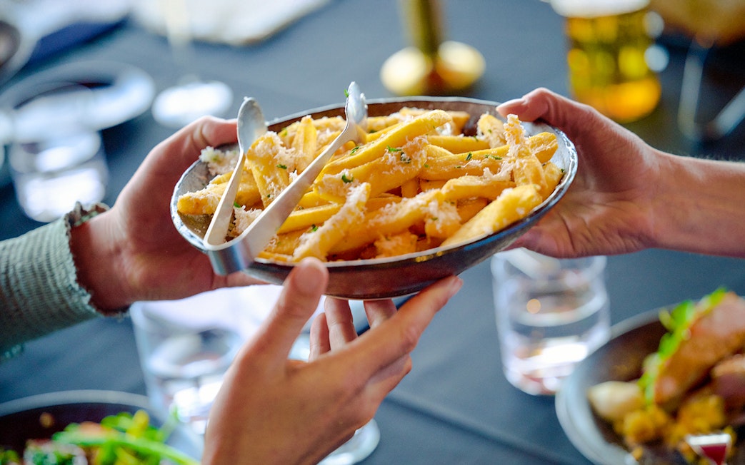 Sharing a plate of fries at Melbourne Skydeck's Altitude dining experience.