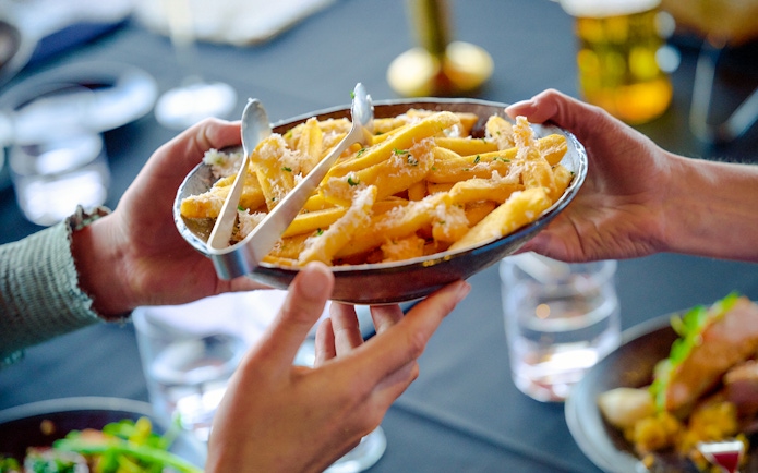 Sharing a plate of fries at Melbourne Skydeck's Altitude dining experience.