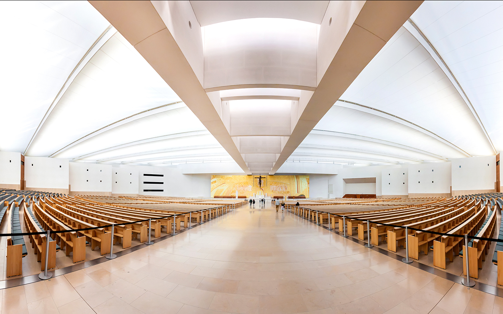 Interior of the Sanctuary of Fátima with rows of wooden pews, part of the Fátima & Coimbra tour.