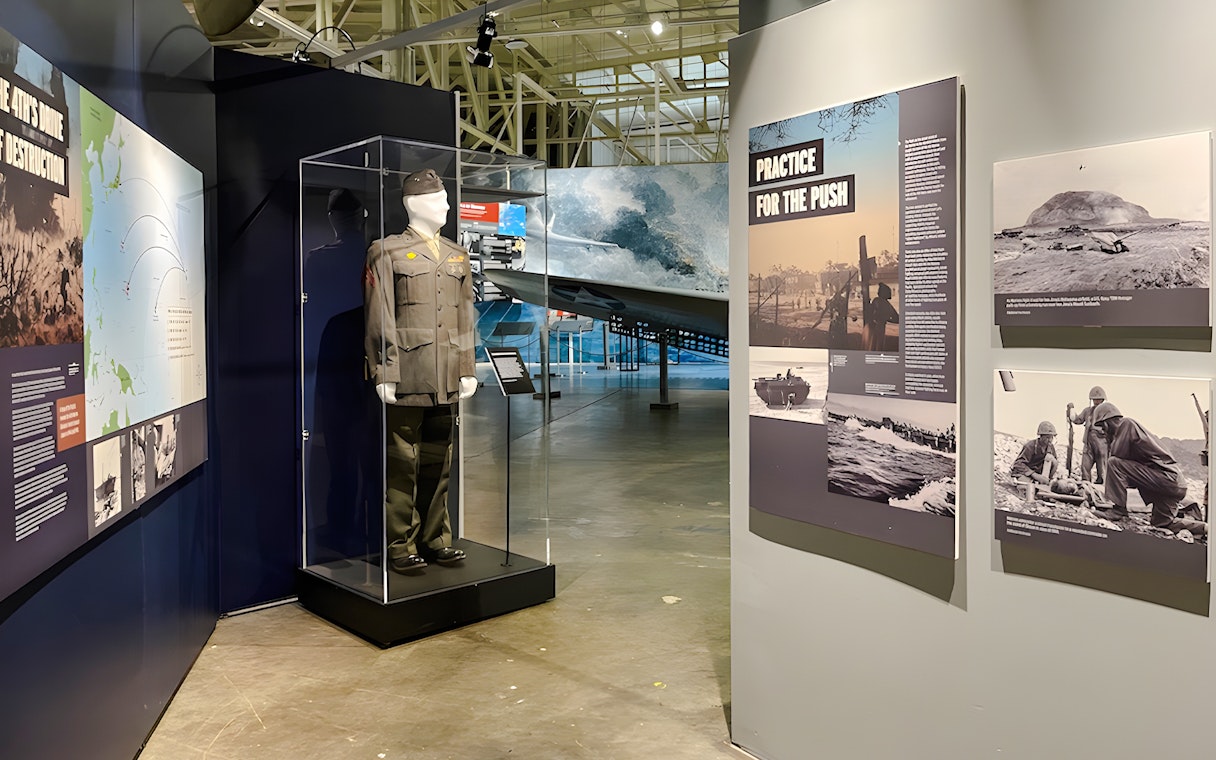 Exhibit of military uniform and historical displays at Pearl Harbor Aviation Museum.