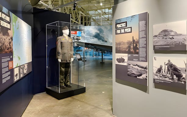 Exhibit of military uniform and historical displays at Pearl Harbor Aviation Museum.