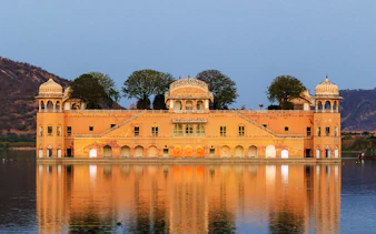 Jal Mahal palace reflecting in Man Sagar Lake, Jaipur, during a guided tour.