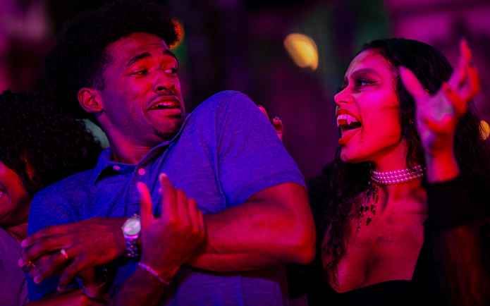 Guests reacting to a vampire character at Knott's Berry Scary Farm in Southern California.