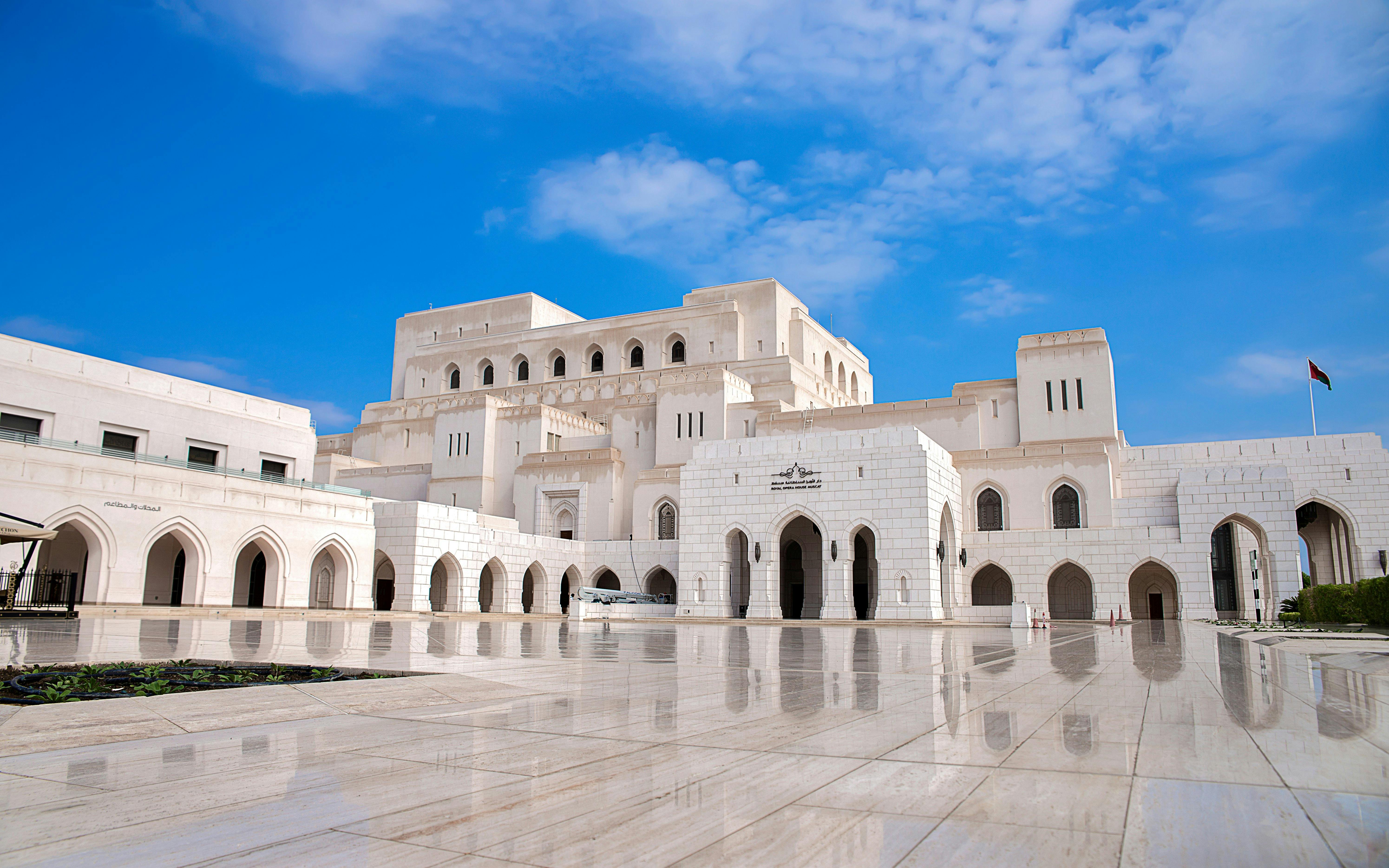 Royal Opera House Muscat exterior with arched facade and courtyard.