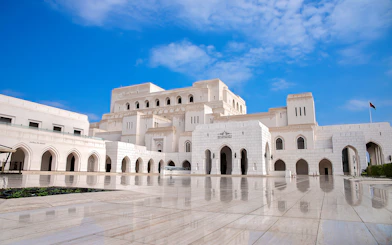 Royal Opera House Muscat exterior with arched facade and courtyard.
