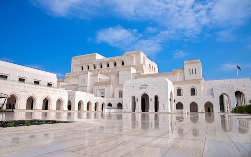Royal Opera House Muscat exterior with arched facade and courtyard.
