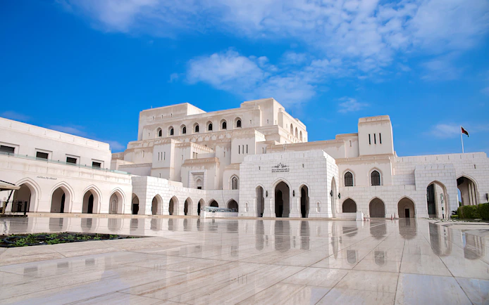Royal Opera House Muscat exterior with arched facade and courtyard.