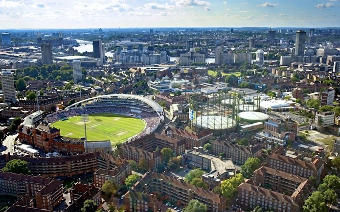 Aerial view of Kia Oval Stadium in London surrounded by cityscape.
