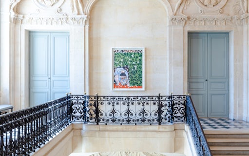 Artwork displayed in the Picasso Museum, Paris, featuring a colorful painting on a decorative wall.